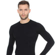 Load image into Gallery viewer, Men&#39;s sleek black ACTIVE WOOL long sleeve crewneck base layer. Pictured with matching ACTIVE WOOL workout leggings